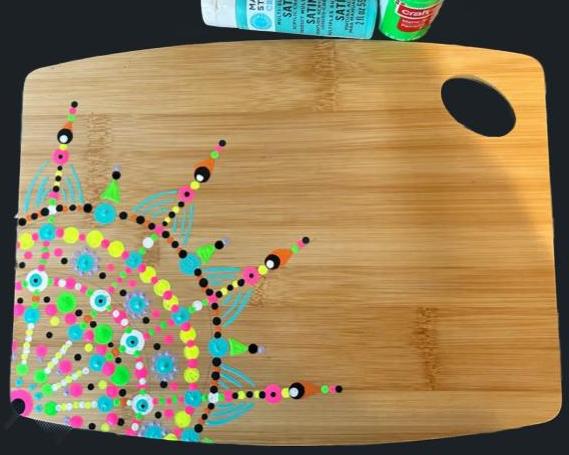 A great example of a customizable mandala charcuterie board that you can paint yourself!